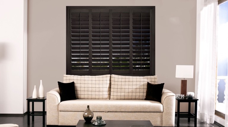 San Antonio sitting room with stained wood shutters.